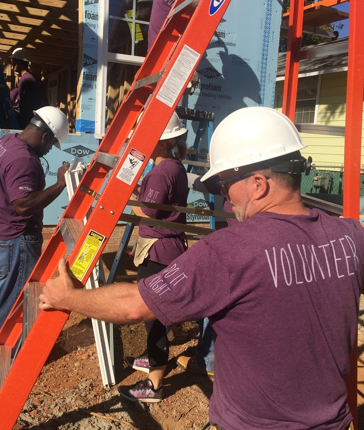Credence Global Bank employees working at Urban Ministries soup kitchen